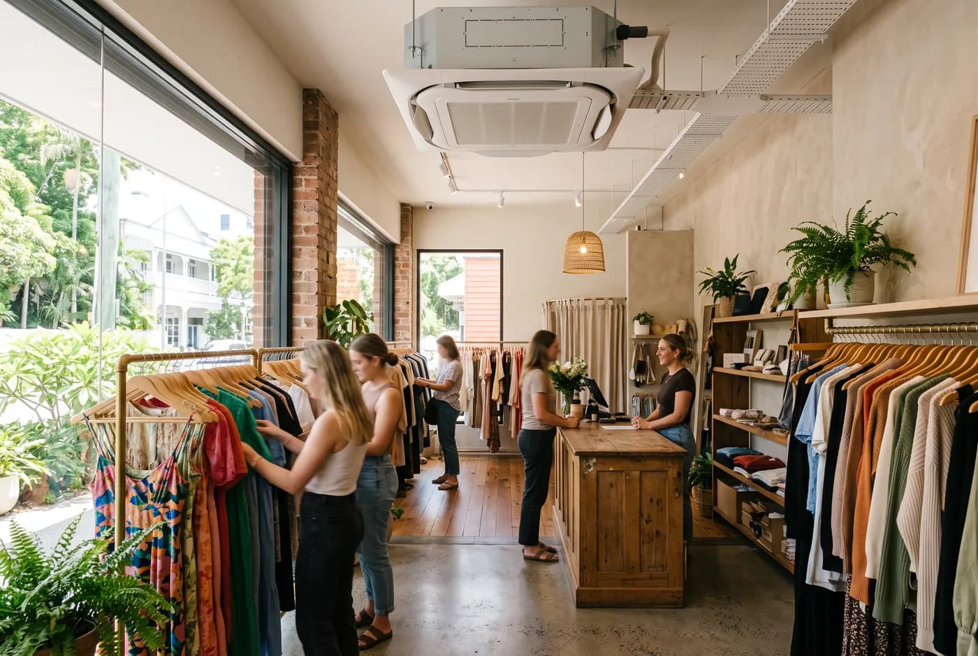 A bright boutique shop with a ceiling cassette air conditioner above the shop floor